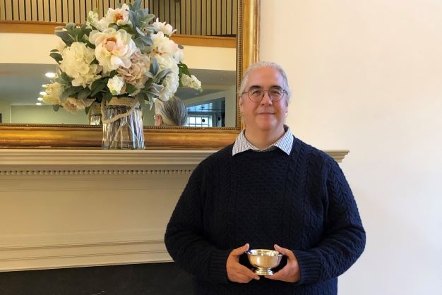 Jim Hollister holds the Robert Gross Award for Advancing Concord's History. 